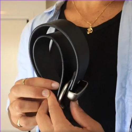 Person holding a black leather belt.